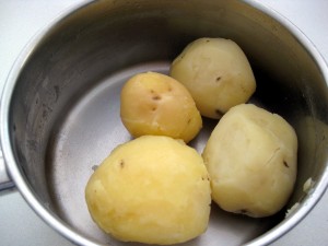 potatoes boiled in their skin for mashing
