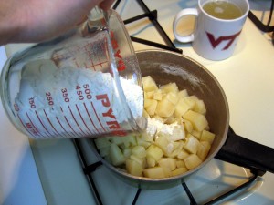 adding flour to potatoes