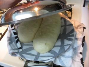 steaming dumpling using a cloth placed over a pot