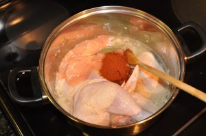 chicken in a pot with paprika and spices