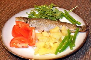 whole trout baked on butter with potatoes and vegetables