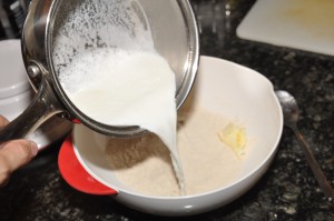 combining flour and milk to make dough for fruit dumpling
