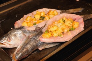 trout stuffed with potatoes before baking