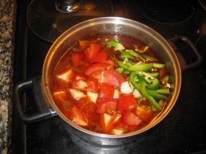 making goulash: tomato and green pepper
