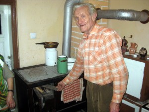 ujo putting wood in the stove