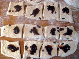 dough cut into squares with plum jam filling