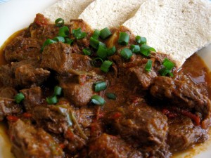 hungarian goulash served with few slices of steamed dumpling