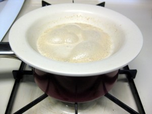 warming up yeast by placing the bowl on top of a pot containing hot water