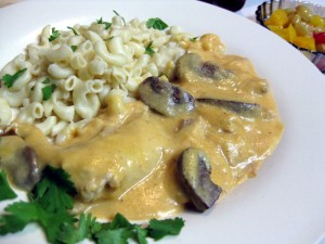 delicious stewed rabbit on mushroom in vegetable sauce with macaroni and fruit cocktail králik na šampiňónoch