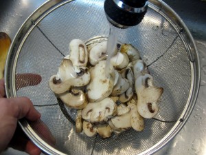 washing sliced mushrooms