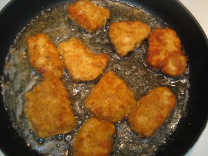 wiener schnitzels frying in oil