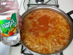 adding vinegar to cabbage soup