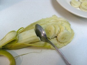 slicing banana with a spoon