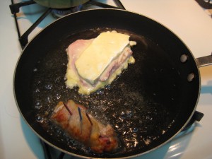 pork rolls being fried and held together by toothpicks