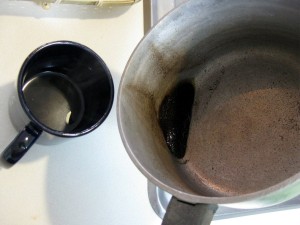 coffee poured from pot to cup with grains left behind