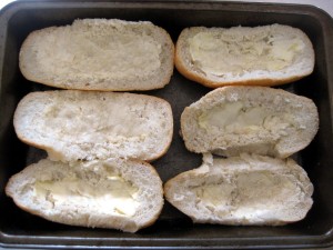 bread rolls sliced in half with butter