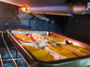 cheese ham mushroom bacon bread rolls toasting under broiler