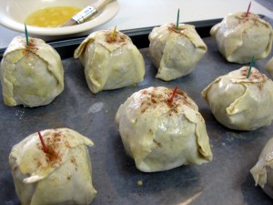 brushing egg onto stuffed apples before baking