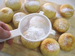 dusting donuts with sugar