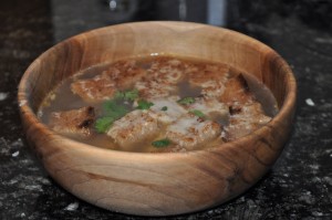 garlic soup with toasted bread, melted cheese, and parsley garnish