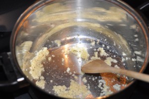 frying garlic cloves on butter