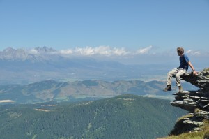 hiking shot with alex sitting on a rock with high tatras in background