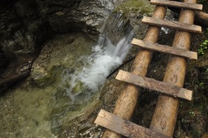 wooden bridge across a waterfall