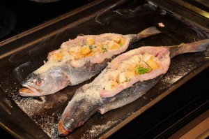 stuffed trout being sewn closed